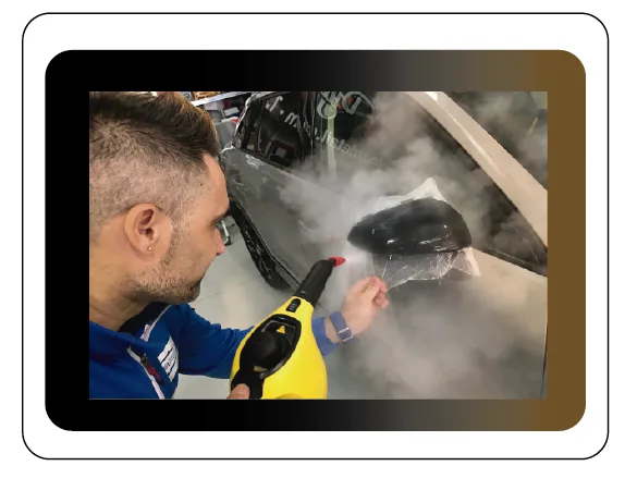 Instructor aplicando PPF en un retrovisor